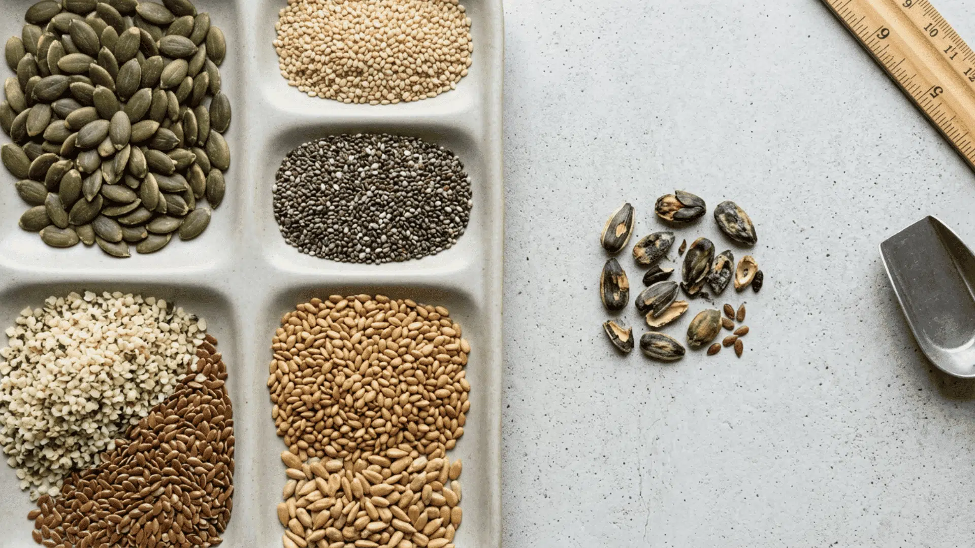 Healthy seeds sorted separately from damaged and discolored seeds on a plain surface